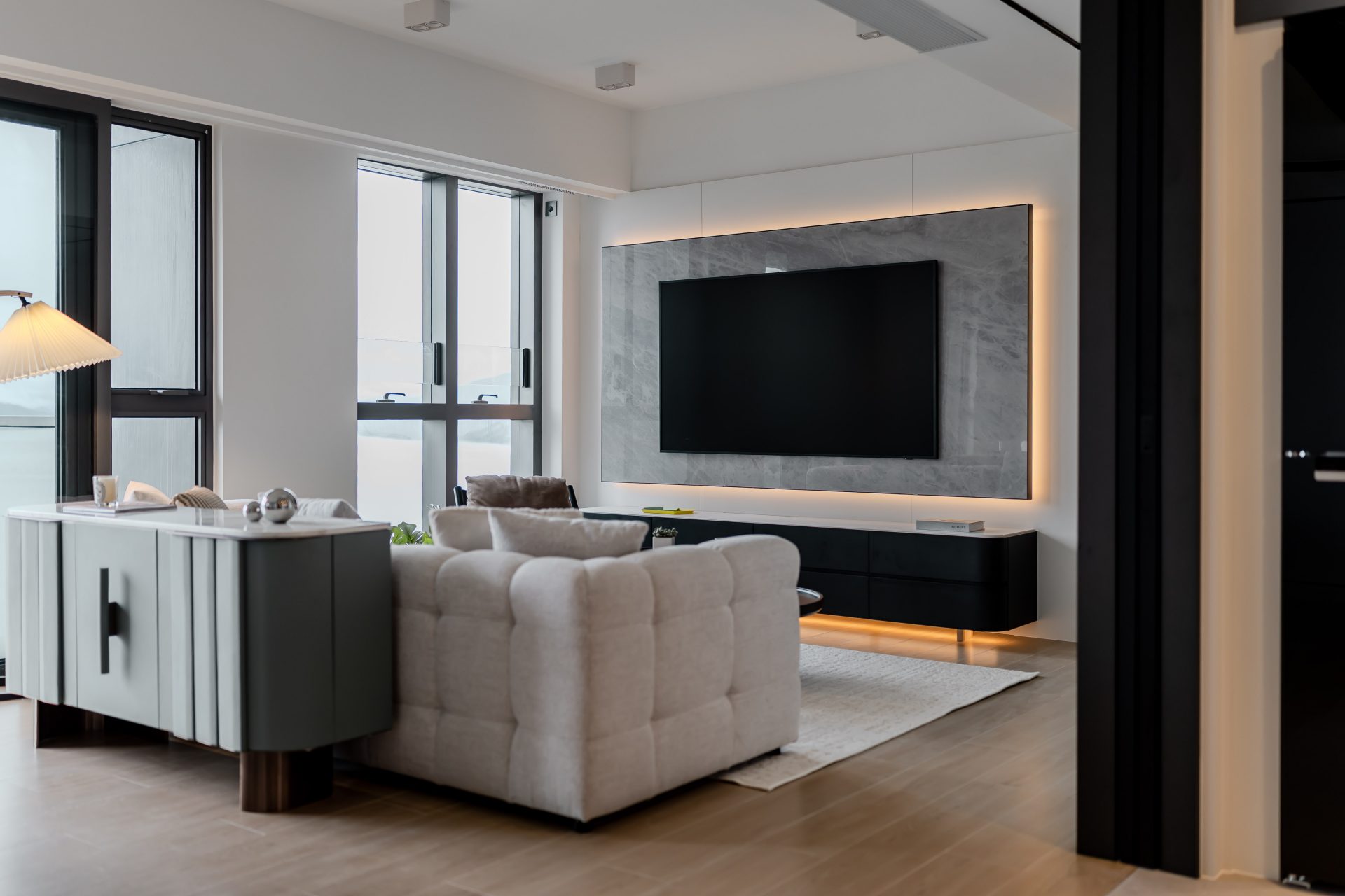 Double Cove — living room with white seating, a dark coffee table and full-height windows